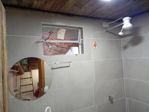 a bathroom with a mirror and a ladder in it at Chalés FRONT LAKE 2 in Córrego do Bom Jesus
