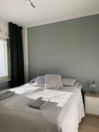 a bedroom with a white bed with two towels on it at Apartments Maaherrankatu in Kuopio