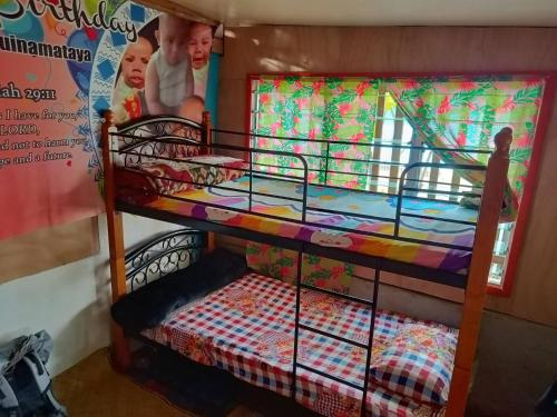 a bunk bed with a crib in a room at Phantom rock view homestay in Namara