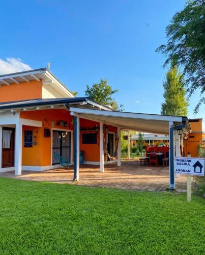 an orange and white house with a patio at BARRIO VIEJO in Los Reartes