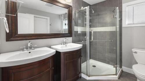 a bathroom with two sinks and a shower at Congress Cottage in Cape May
