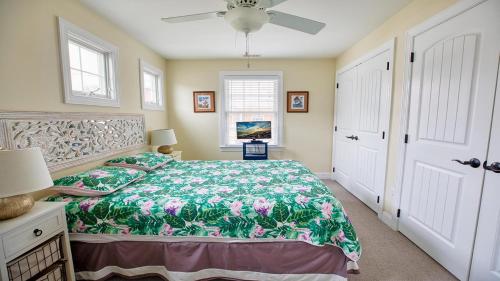 a bedroom with a bed and a ceiling fan at Congress Cottage in Cape May