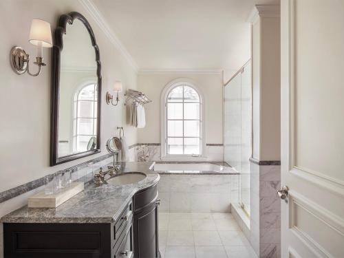 a bathroom with a sink and a tub and a mirror at Liora Estate in Healdsburg