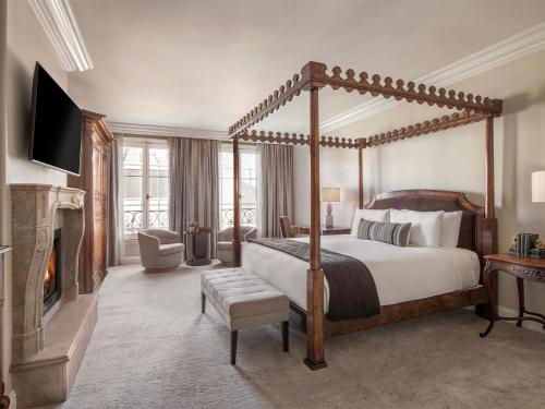 a bedroom with a canopy bed and a fireplace at Liora Estate in Healdsburg