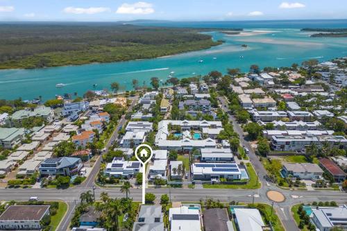 an aerial view of a resort with the ocean at Modern airy duplex steps to River heated pool in Noosaville