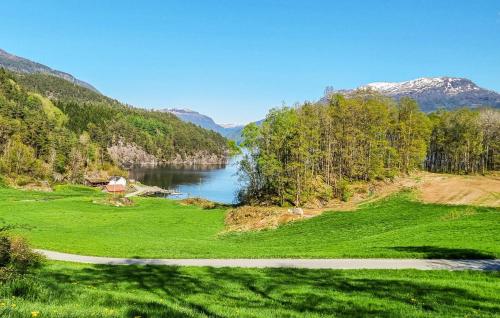 a lake in the middle of a green field at Sjøhytta in Vanvik