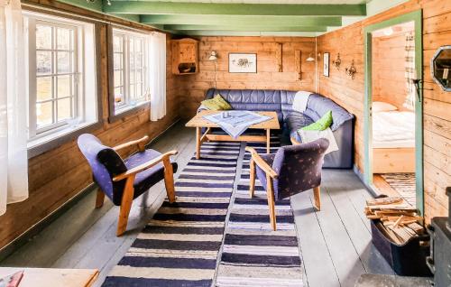 a room with a couch and a table and chairs at Sjøhytta in Vanvik