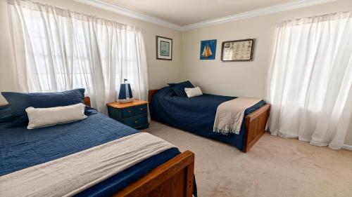 a bedroom with two beds and a window at West Cape Estate in West Cape May