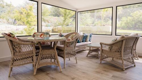 a room with a table and chairs and a couch at Kingfisher Cottage in Broughton Vale