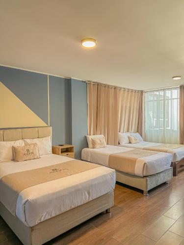 two beds in a hotel room with two bedsvisor at Andari Hoteles in Arequipa
