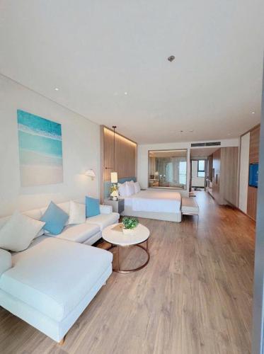 a living room with two beds and a couch at À La Carte Hạ Long in Ha Long