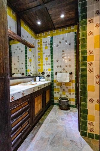 a bathroom with a tub and a sink in it at Posada de las Flores Loreto in Loreto