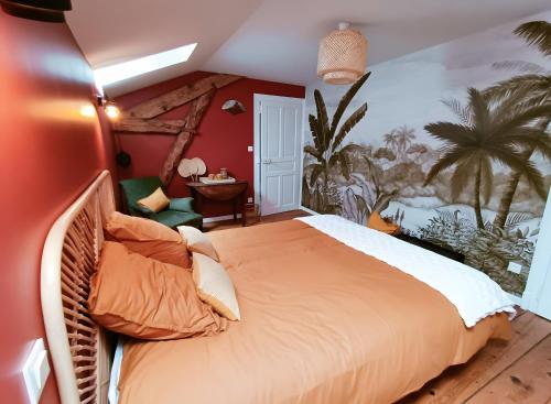 a bedroom with a large bed and a palm tree mural at Chambre d'hôtes Le Colibri in Épinal
