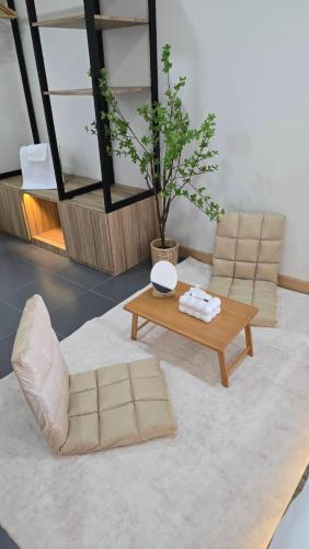 a living room with a couch and a coffee table at Sleep Owl Surat Thani in Surat Thani