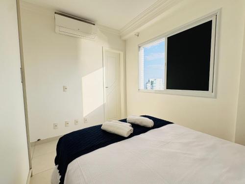 a bedroom with a bed with two towels on it at Studio Mandarin + spectacular view + Umarizal in Belém