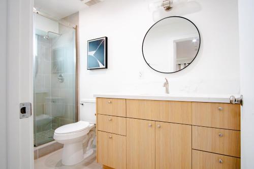 a bathroom with a sink and a toilet and a mirror at Jardin Noir at Case Collective in North Hollywood