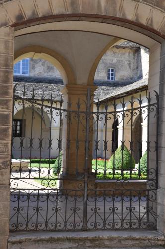 an entrance to a building with an iron gate at L' Atelier de la Monnaie in Crémieu