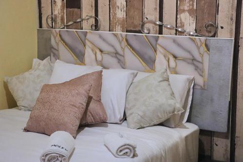 a bedroom with a bed with pillows and a headboard at Molejo Guest House in Palatswe