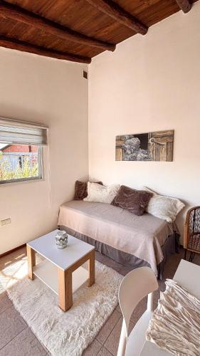 a living room with two beds and a table at Trono de Nubes in Trevelín