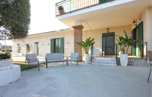a patio with two chairs and a table at Villa Angela Holiday Apartment in Angri
