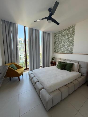 a bedroom with a large bed with a ceiling fan at Paradise in a rainforest reserve B 503 in Playa del Carmen
