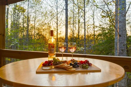 a table with two glasses of wine and cheese at Grizzly Glam in Gatlinburg