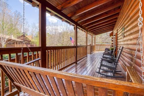 a porch with rocking chairs and an american flag at Six-Bedroom House in Pigeon Forge