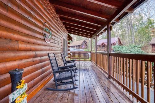 two chairs sitting on the porch of a cabin at Six-Bedroom House in Pigeon Forge
