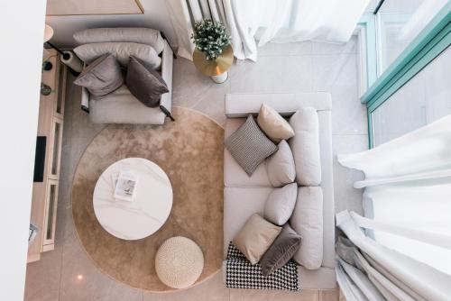a living room with a table and a couch at La,mer Butik Hotel in Kota Kinabalu