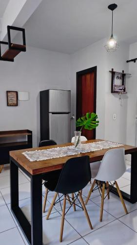 a kitchen with a large wooden table and chairs at Aconchego e Estilo em Brusque in Brusque
