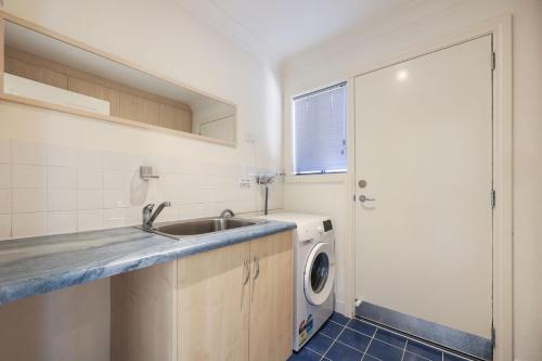 a kitchen with a sink and a washing machine at 41 Blanche Pde, Hindmarsh Island in Hindmarsh Island