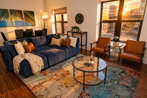 a living room with a blue couch and a glass table at Spacious 3BR 420 Friendly Apartment Near McCormick Place, Lakefront and Soldier Field in Chicago