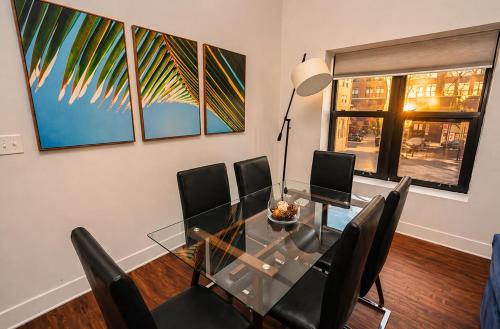 a dining room with a glass table and chairs at Spacious 3BR 420 Friendly Apartment Near McCormick Place, Lakefront and Soldier Field in Chicago
