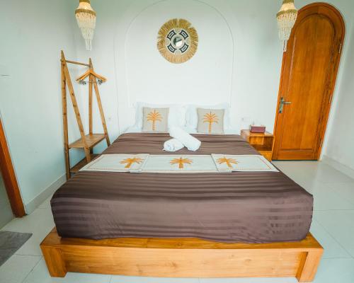 a bedroom with a large bed with a wooden frame at Hideout Kintamani and Hot Spring in Kintamani