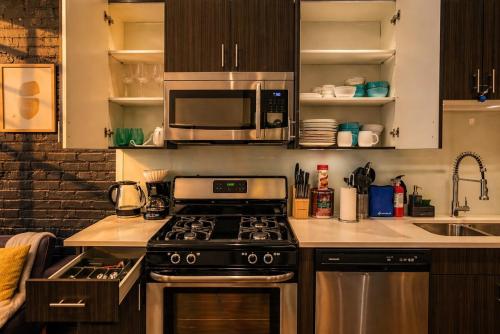 a kitchen with a stove and a microwave at Modern 2BR 420 Friendly in Chicago South Loop Near Museum Campus, McCormick Place and Soldier Field in Chicago