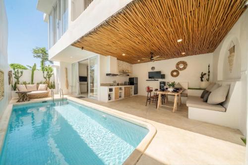 a swimming pool in a villa with a living room at Casa Sud - Secluded Pool Villa in Uluwatu in Uluwatu