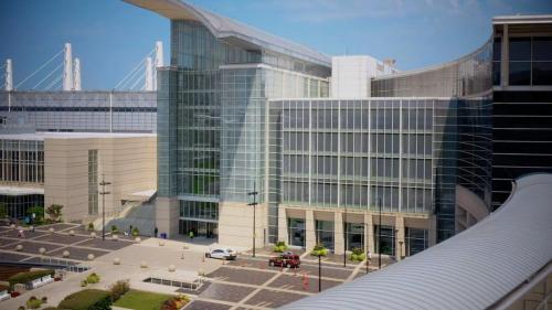 a large glass building with a parking lot in front of it at Stylish Cozy 3BR 420 Friendly Apartment with Gym Near McCormick Place, Grant Park and Soldier Field in Chicago