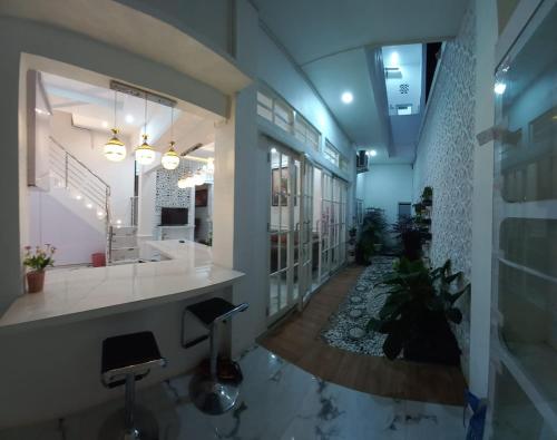 a large lobby with a reception counter and stools at Batu Villa Sakura in Batu