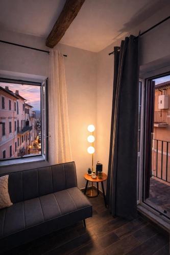 a living room with a couch and a large window at Sole Suite & Boutique Rooms in Norma