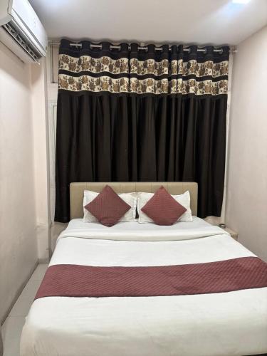 a bedroom with a large bed with black curtains at The Human Stay in Indore