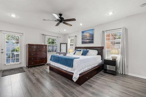 a bedroom with a bed and a ceiling fan at 3BR - Beach & Trail - Bikes, Fire Pit, Mini-Golf in St. Petersburg