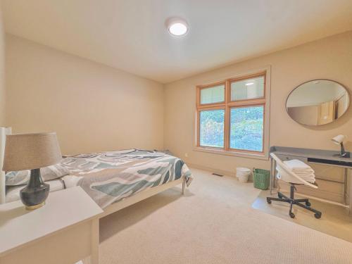 a bedroom with a bed and a desk and a mirror at Quiet Private Room with Ensuite - Broadmead 908 in Victoria