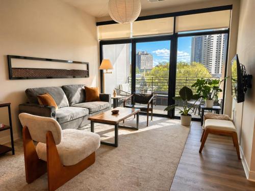 a living room with a couch and a large window at East Side Luxury 1BR Apt - Near Brady St with Balcony and Lounge in Milwaukee