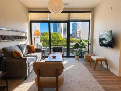 a living room with a couch and a tv at East Side Luxury 1BR Apt - Near Brady St with Balcony and Lounge in Milwaukee