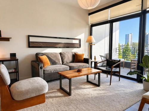 a living room with a couch and a table at East Side Luxury 1BR Apt - Near Brady St with Balcony and Lounge in Milwaukee