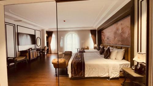 a hotel room with a bed and a glass wall at Bảo Long Lào Cai Hotel in Lao Cai