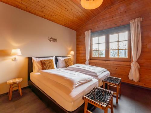 a bedroom with a large bed and a window at TraumLodge in Kleinsonnberg