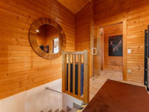 a log cabin with a mirror and a walk in shower at TraumLodge in Kleinsonnberg