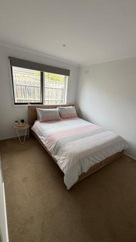 a large bed in a bedroom with a window at Weekend Escape in Rosebud