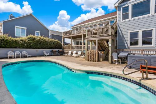 a swimming pool in front of a house at 6120 - Yankee Clipper in Nags Head